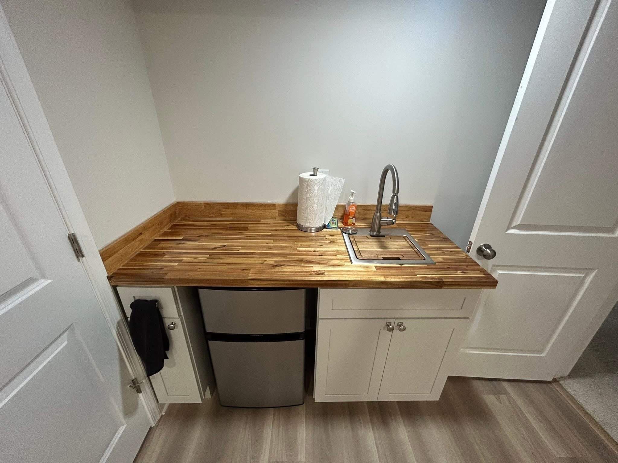 Basement with custom kitchenette and wood countertops