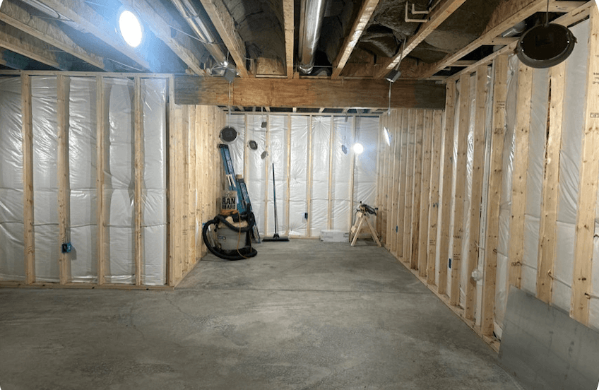 Basement before drywall installation showing framing